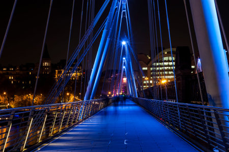 People walking on a modern bridge in Londonの写真素材