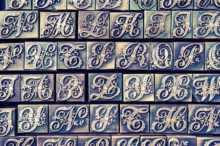 Vintage decorated letterpress alphabet background with cross process photographic effectの写真素材