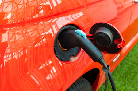 Electric red car in a charging stationの写真素材