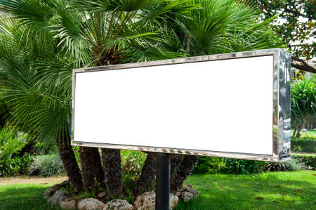 White billboard in a garden with palmsの写真素材