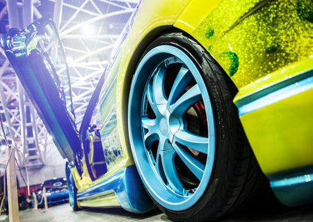 Yellow modern sport car illuminated in a salon