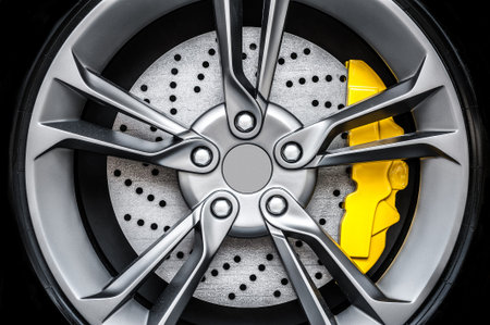 Close up of a modern sport wheel with yellow brakeの写真素材