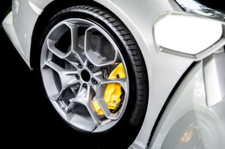 Close up of a modern sport wheel with yellow brakeの写真素材