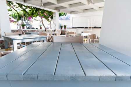 White wooden table with restaurant on background out of focusのeditorial素材