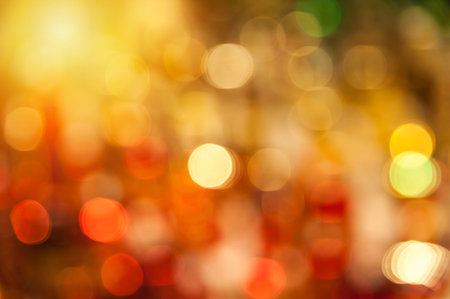 Yellow and red bokeh background created by neon lights