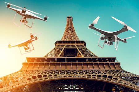 Many drones with digital camera flying around Tour Eiffel: 3D renderingの写真素材