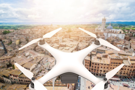 Drone with digital camera flying over an old city: 3D rendering