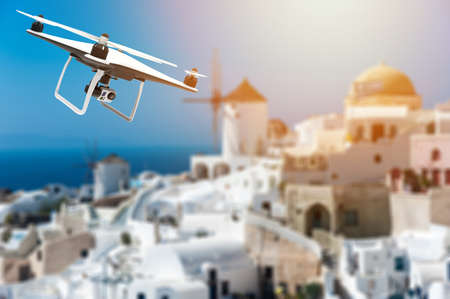 Drone with digital camera flying over a greek city: 3D renderingの写真素材