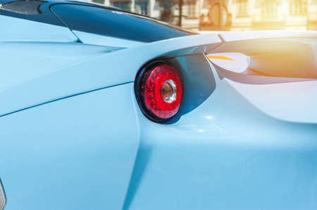 Back of a blue sport car in sunset backgroundの写真素材