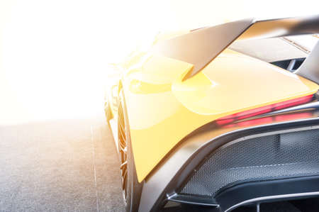 Back of a yellow sport car in sunset backgroundの写真素材