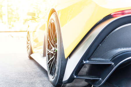 Back of a yellow sport car in sunset light backgroundの写真素材