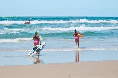 GOLD COAST, SURFERS PARADISE, QLD,  AUSTRALIA - Feb. 2013: C. Falzon (5) A. Richardson (8) compete on the round four of the Surf Ironwoman Series National Championship on February 09th 2013, Gold Coast Australia.のeditorial素材