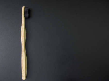 Eco Friendly Bamboo Toothbrush on black background. Zero waste, no plastic. Copy space.の写真素材