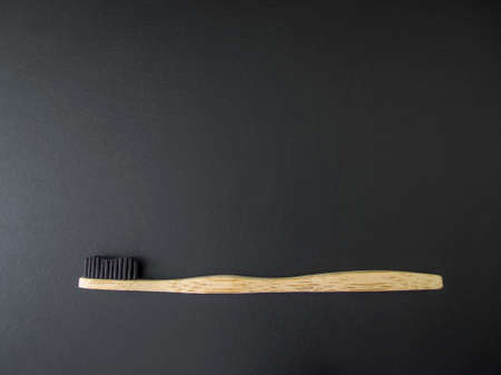 Eco Friendly Bamboo Toothbrush on black background. Zero waste, no plastic. Copy space.の写真素材