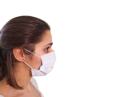 Portrait of a woman wearing a medical protective face mask against coronavirus. Isolated. White...