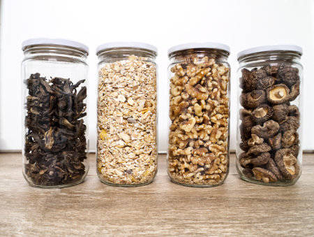 Bulk foods storage in glass jars: dry wild mushrooms, muesli and nuts. Zero waste concept.