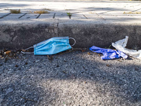 Used medical masks and gloves on the floor. Coronavirus concept.の写真素材