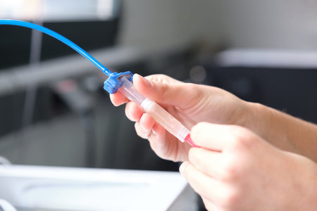 Researcher loading the ink cartridge of a 3D bioprinter to 3D print cells onto an electrode....