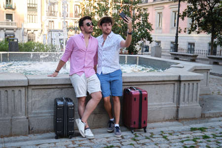 Couple of tourist taking a selfie at fountain in a city.の写真素材