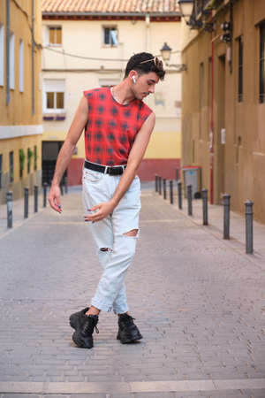 Young caucasian man with long false nails dancing at street, steps of contemporary dance.の写真素材