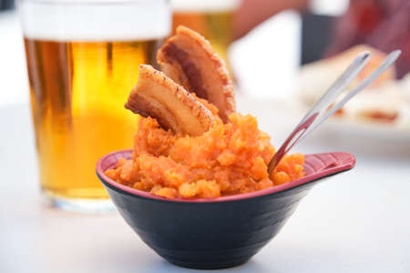 Patatas machaconas, mashed potatoes with torreznos, paprika and garlic.の写真素材