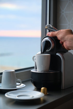 Hand preparing coffee in a coffee machine with capsules.の写真素材