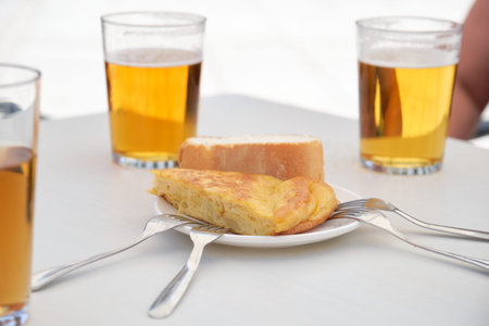 Beers and a piece of Spanish omelette.の写真素材