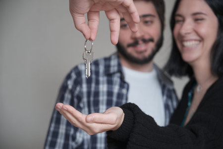 Close up of a young couple receiving the keys of their new apartment.
