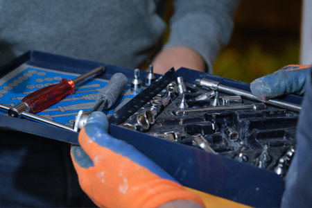 Constructor workers hands holding a torque wrench set.