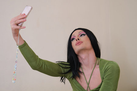 Drag queen person takes a selfie with the smartphone.