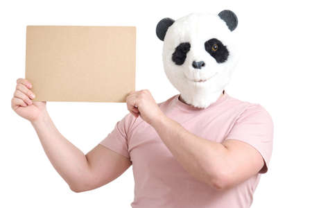Man wearing a panda mask head holding white empty banner, isolated on white background in studio.の写真素材
