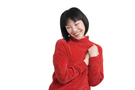 Young asian woman reminiscing about love wearing winter red sweater, isolated on white background.