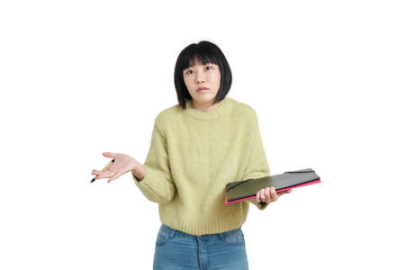 Young asian student woman shrugging, wearing winter green sweater, isolated on white background.の写真素材