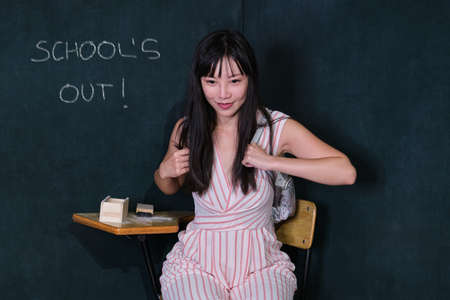 Young asian woman pretending to be a child go to school summer holiday after the class.の写真素材
