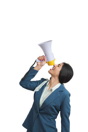 Young Venezuelan businesswoman shouting through megaphone. Isolated over white background.の写真素材
