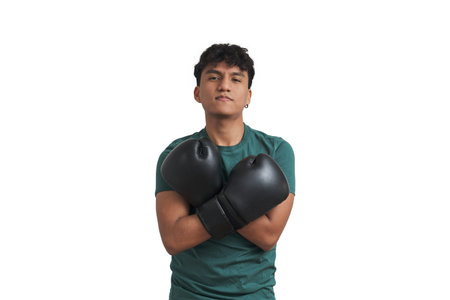 Young peruvian boxer posing with boxing gloves on his chest. Isolated over white background.