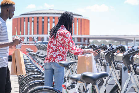 Young african tourists renting a bike at a bicycle rental service machine. City life concept.の写真素材