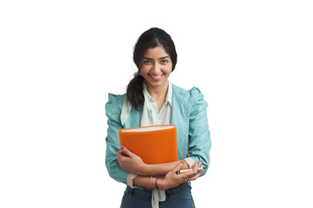 Young Venezuelan businesswoman smiling and looking at camera with a folder. Isolated over white background.の写真素材