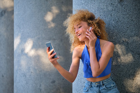 Portrait of young Brazilian woman wearing earphones listening music in a summer day.