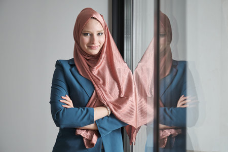 Portrait of young muslim businesswoman wearing hijab in office near by a window.の写真素材