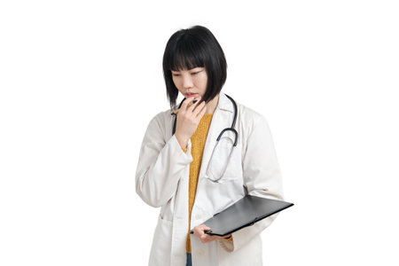 Young asian female doctor worried, isolated on white background.の写真素材