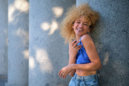 Portrait of young Brazilian woman laughing and looking at camera.の写真素材
