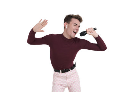 Young caucasian man singing with a microphone. Isolated over white background.