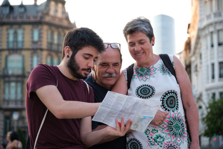 Family consulting a city guide in Bilbao, Spain.