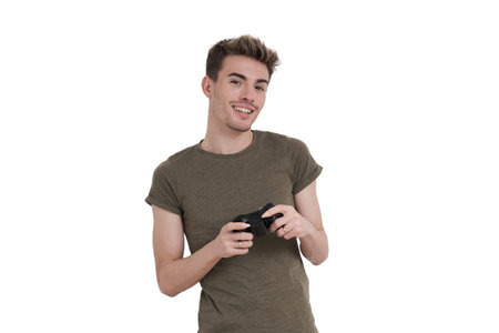 Young caucasian man smiling with a joystick. Isolated over white background.