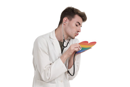 Young caucasian male doctor taking care of lgbt flag heart, isolated over white background.の写真素材