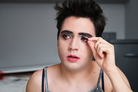 Young drag queen removing false black eyelashes.の写真素材