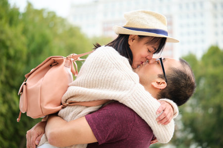 Multiracial couple of tourists kissing and enjoying travel together. Sightseeing in Madrid, Spain.の写真素材