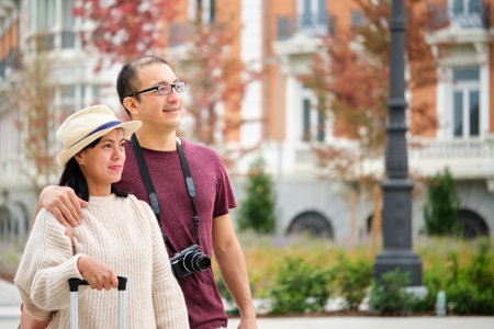 Multiracial couple of tourists exploring the city together. Sightseeing in Madrid, Spain.の写真素材