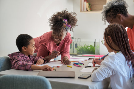 African mothers helping children do their homework. Horizontal extended family.の写真素材